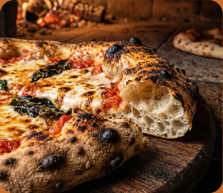 Pizza baking in a wood-fired oven
